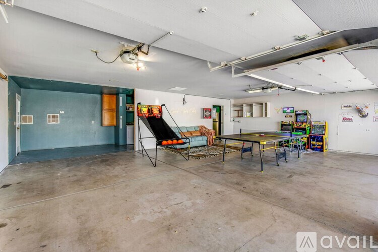 A room with a ping pong table and a foosball table.
