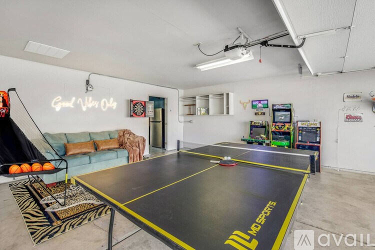 A room with a trampoline and a table tennis table.