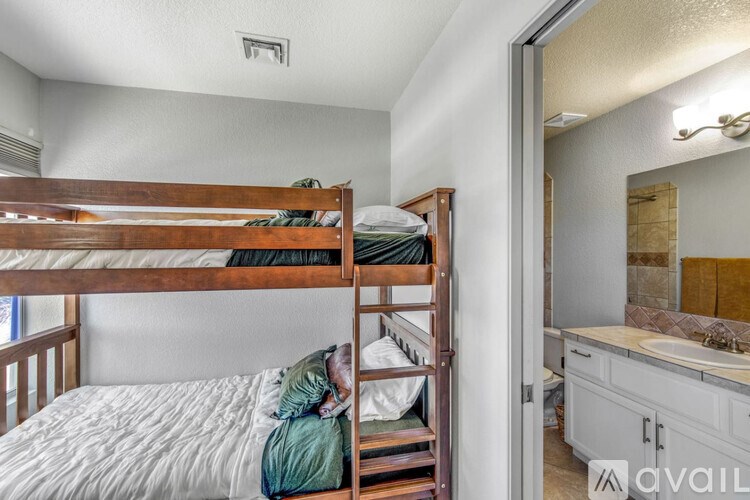 A bedroom with a bunk bed and a mirror.