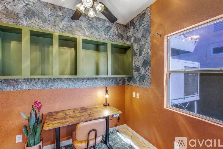 A room with orange walls and a table with chairs.