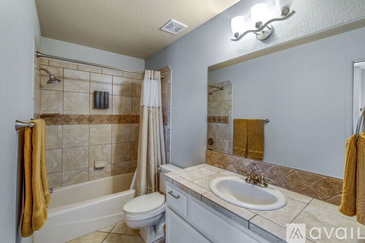 A bathroom with a toilet, sink, and bathtub.