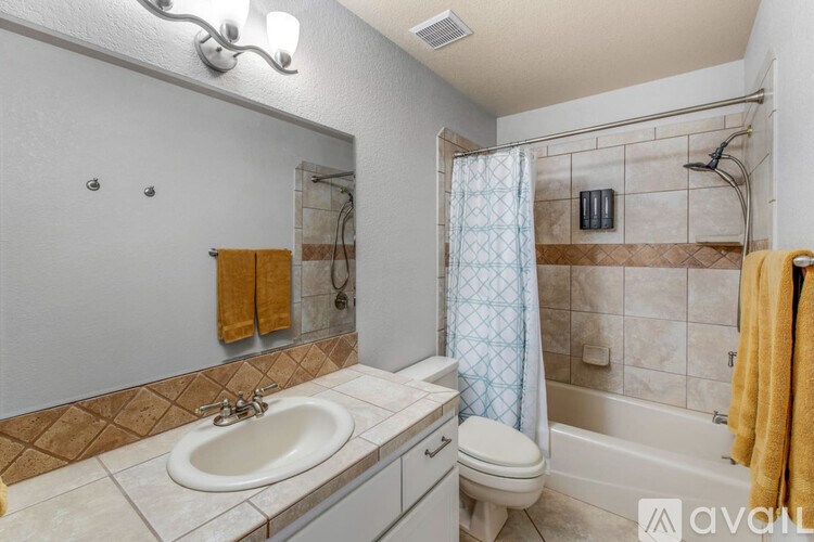 A bathroom with a sink, toilet, and bathtub.