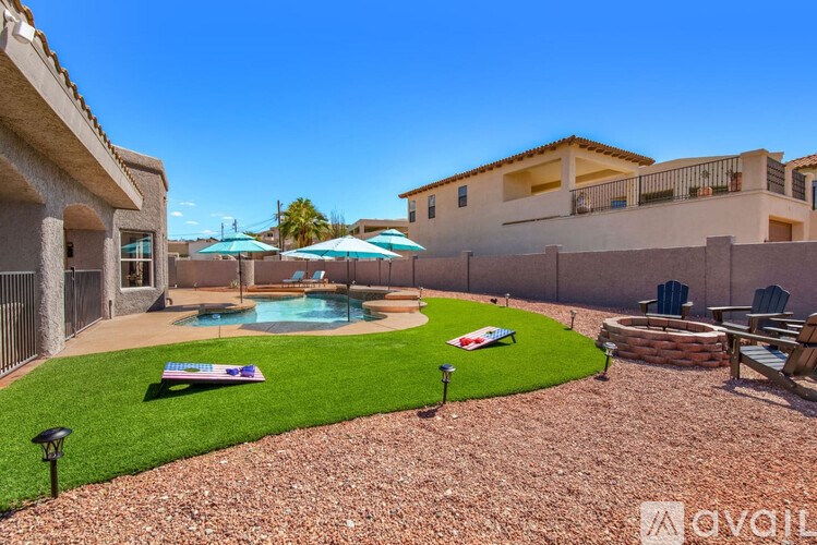 A backyard with a pool and a lawn.