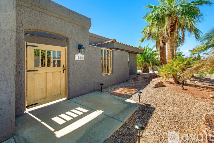 A house with a brown door and a number 1800 on it.