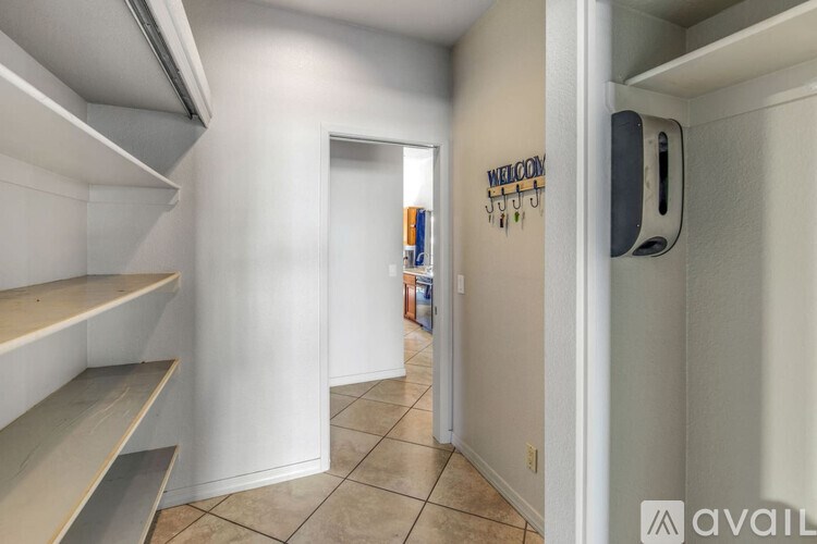 A kitchen with a wall that says "welcome" on it.