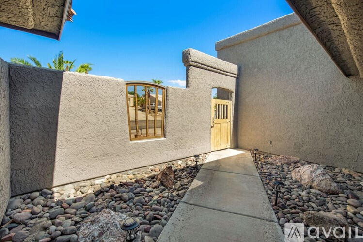 A concrete building with a wooden door and window.