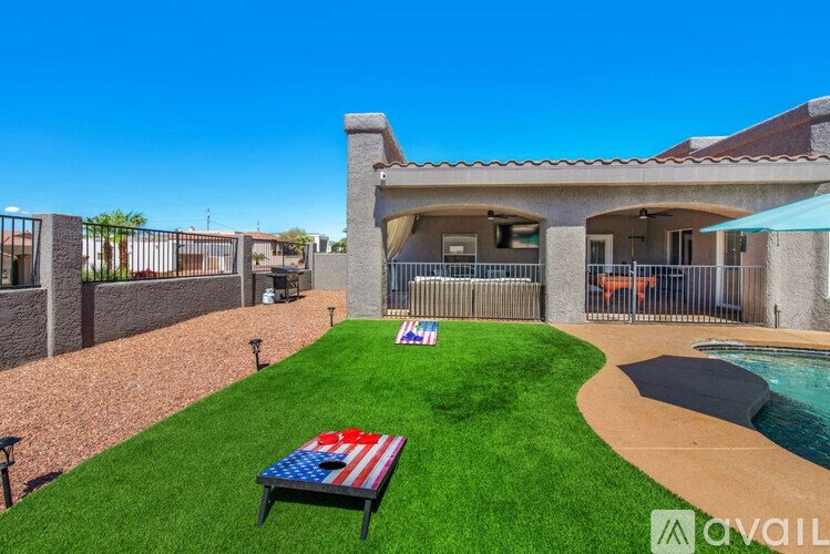 A backyard with a pool and a flag on the lawn.