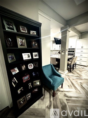 A black bookshelf with many pictures on it.