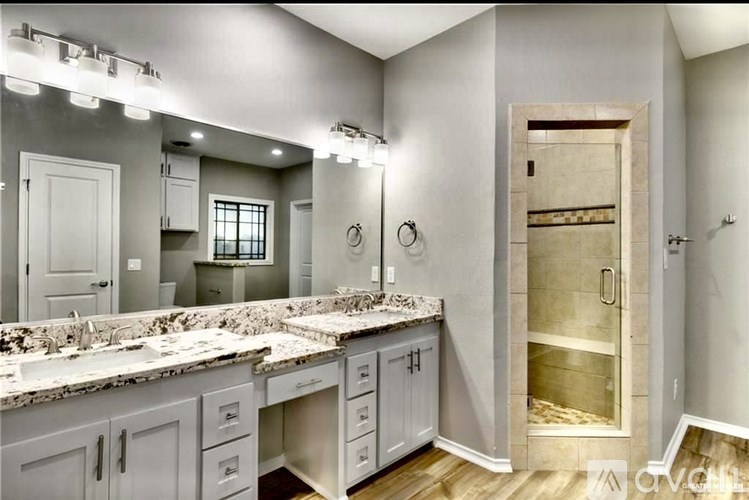 A bathroom with a vanity and a walk-in shower.
