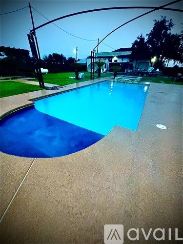 A pool with a blue tinted water.
