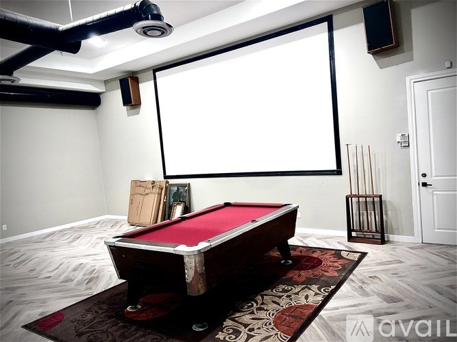 A pool table with a red cloth and a white background.