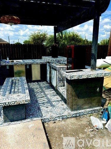 A patio area with a bench and a table.