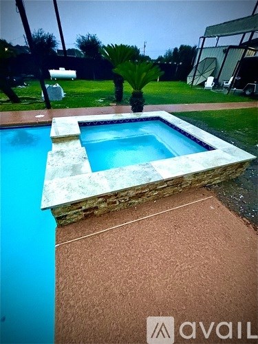 A pool with a stone border and a brownish floor.