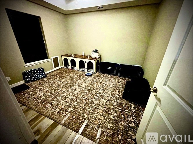 A room with a patterned carpet and a white door.