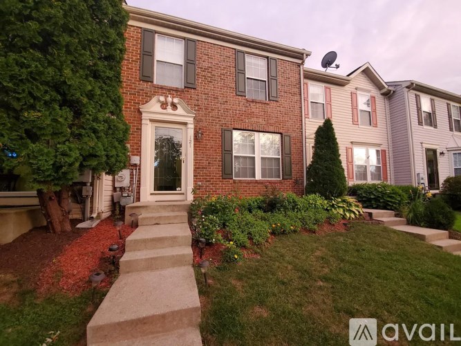 A house with a red brick facade and a white door is shown.