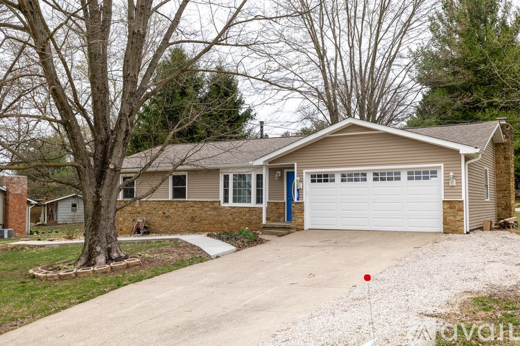 A house with a garage is for sale.