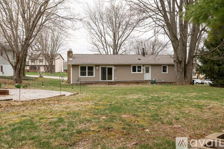 A house with a grey roof and a green lawn in front.
