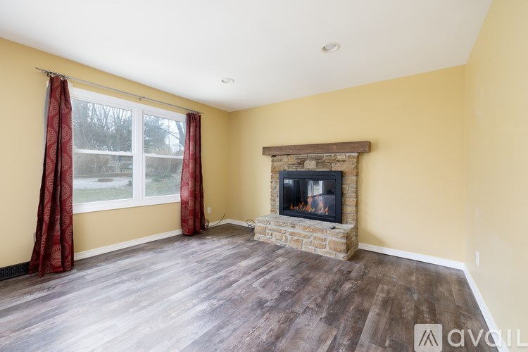 A room with a fireplace and wooden floors.