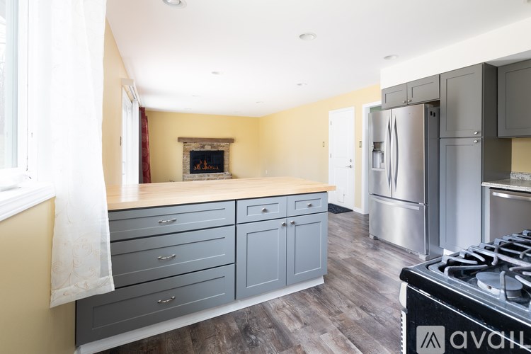 A kitchen with a stove top oven and a fireplace.