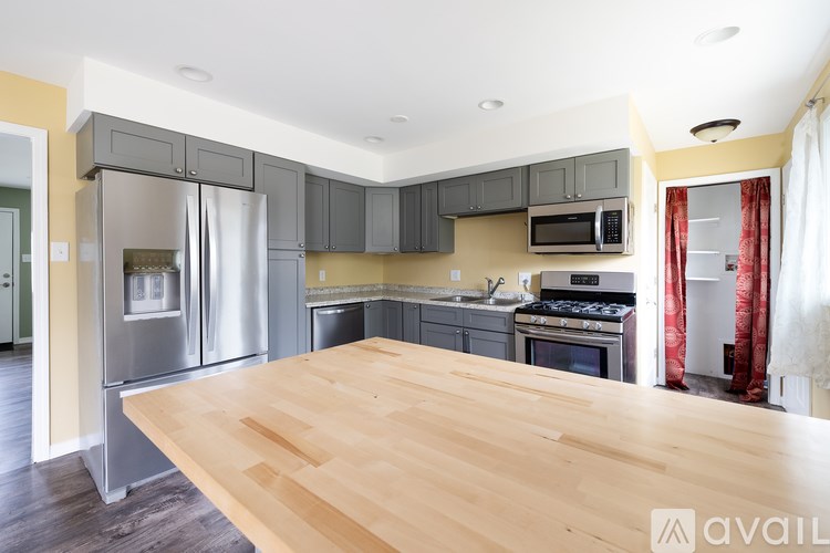 A kitchen with wooden floors and stainless steel appliances.