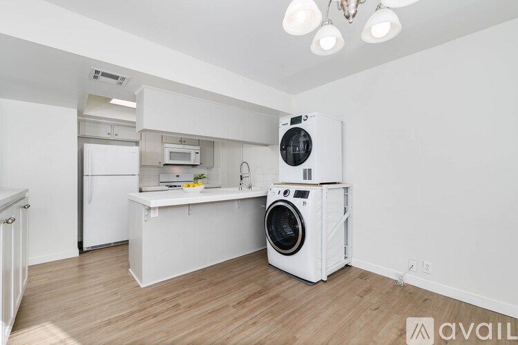 A white washing machine and dryer in a laundry room.