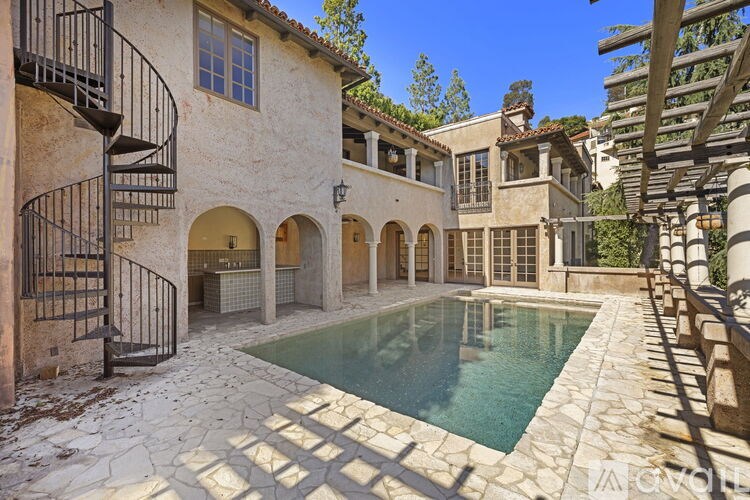 A pool in a courtyard surrounded by buildings.