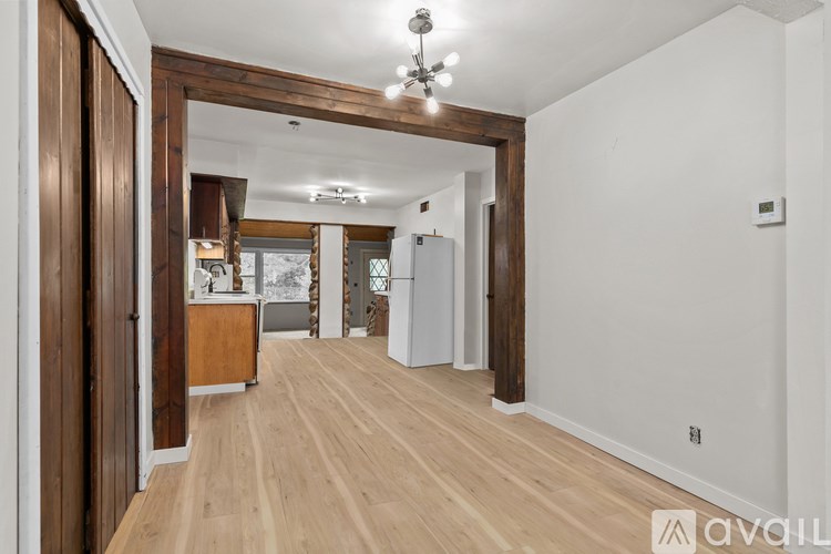 A room with wooden floors and a white wall.