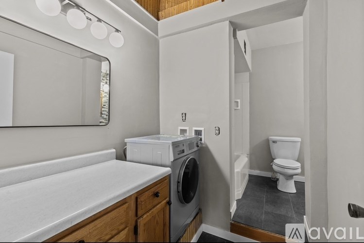 A small laundry room with a washer and dryer.