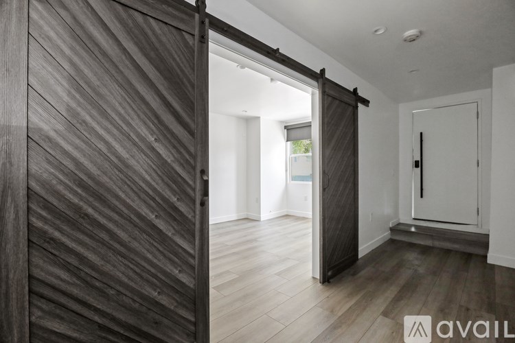 A room with a wooden floor and a sliding door.