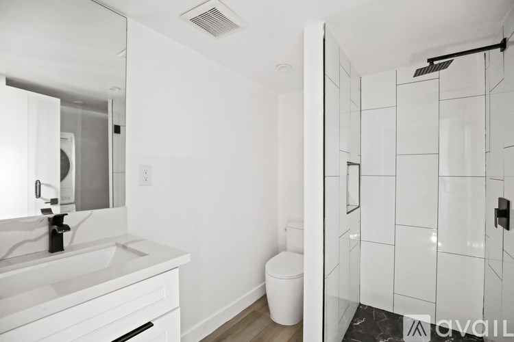 A bathroom with a white sink and toilet.