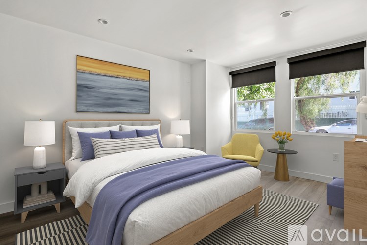 A bedroom with a large bed and a painting on the wall.