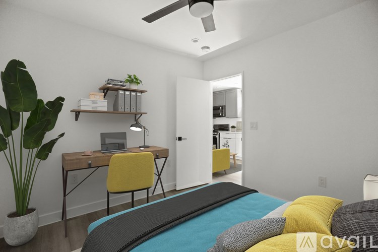 A bedroom with a bed, desk, and chair.