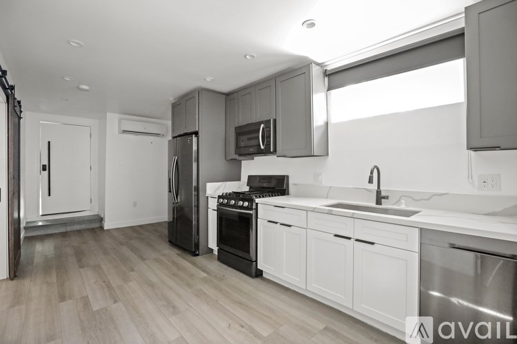 A kitchen with a stove, oven, and sink.