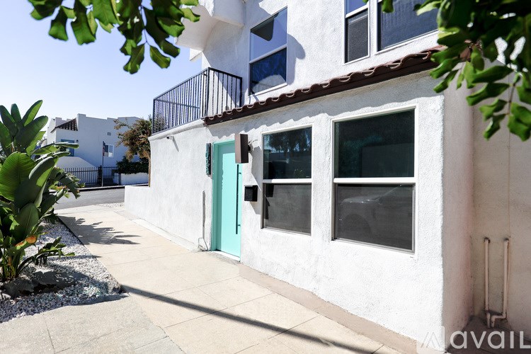 A white house with a blue door and windows.