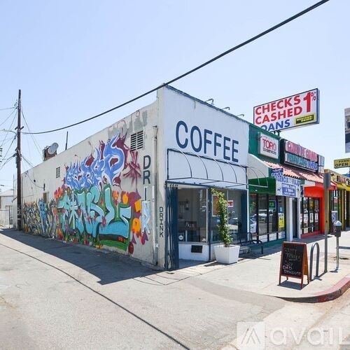 A coffee shop with a mural on the side of the building.