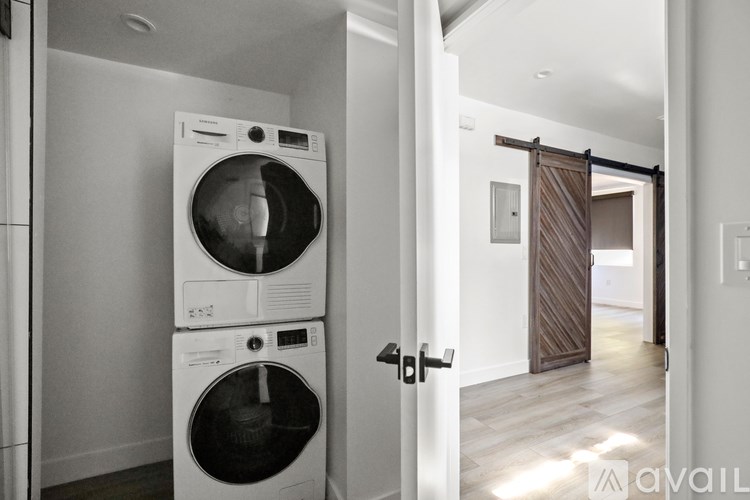 A washing machine and dryer stacked on top of each other in a laundry room.