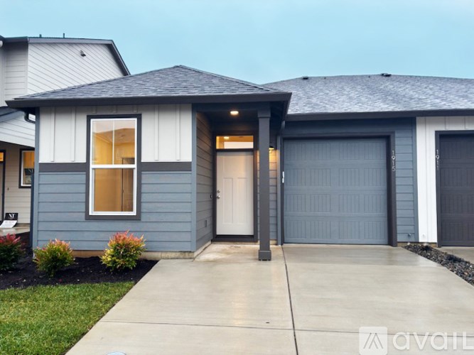A house with a blue exterior and a grey roof.