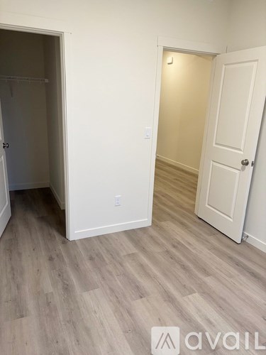 A room with a white door and a white wall.