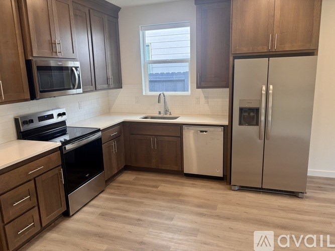 A kitchen with wooden cabinets and stainless steel appliances.