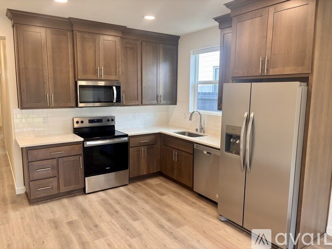 A kitchen with wooden cabinets and stainless steel appliances.