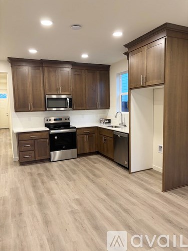 A kitchen with wooden cabinets and a white fridge.