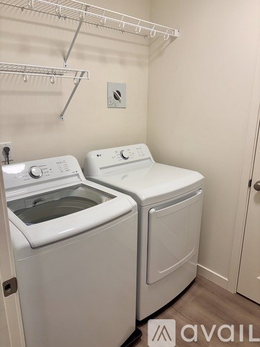 A small laundry room with a washer and dryer.