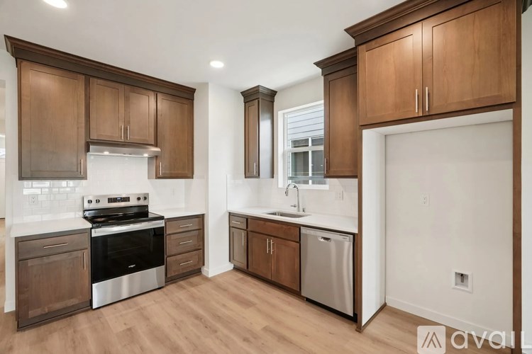 A kitchen with wooden cabinets and stainless steel appliances.