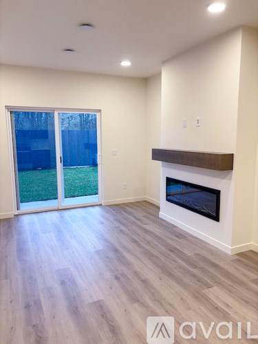 A room with a fireplace and sliding glass doors.