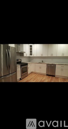 A kitchen with white cabinets and stainless steel appliances.