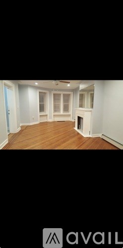 A room with wooden floors and white walls.