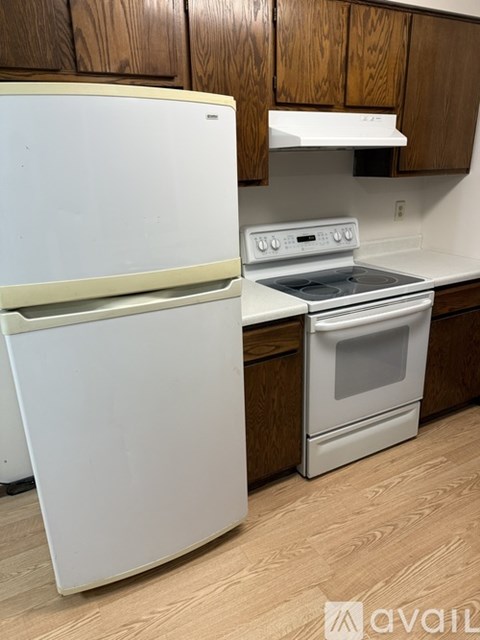 A white refrigerator and stove in a kitchen.