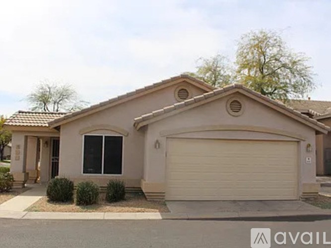 A house with a garage door and a driveway.