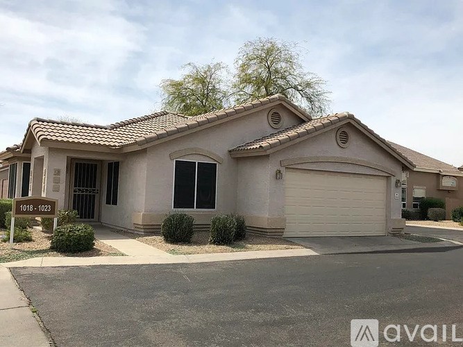 A house with a brown roof and a garage door is for sale.