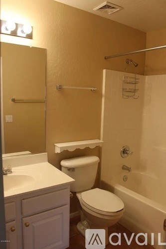 A bathroom with a toilet, sink, and shower.